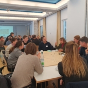 Rege Diskussion an zwei Gruppenarbeitstischen